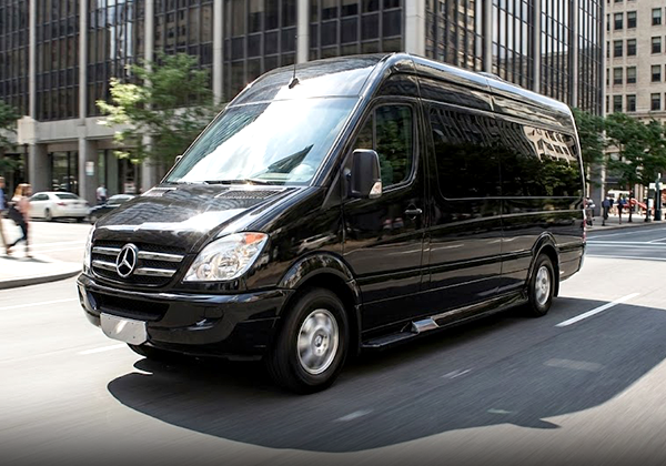 Black Mercedes-Benz minivan driving street