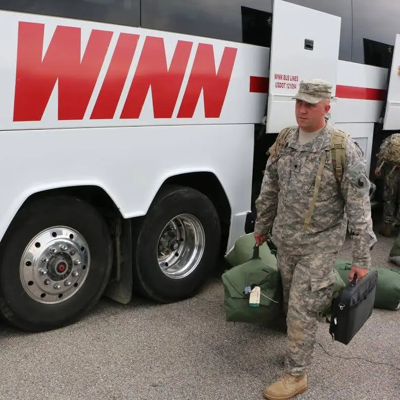 Person in uniform near bus